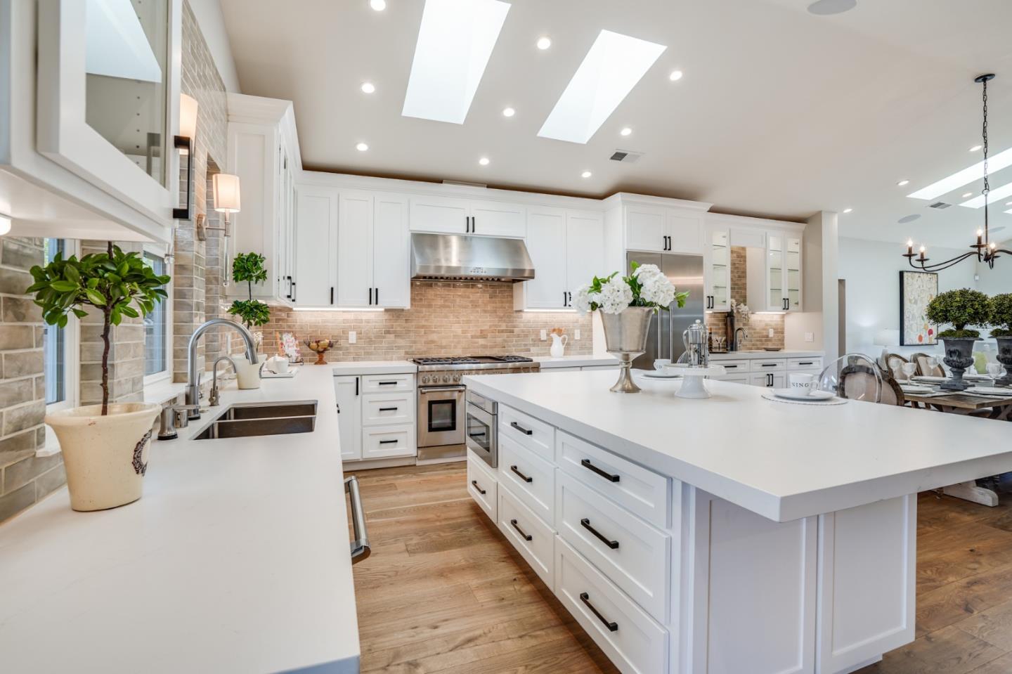 1564 Meadow Lane Mountain View, CA 94040 - Photo 9 of 36 a kitchen with stainless steel appliances sink stove and white cabinets