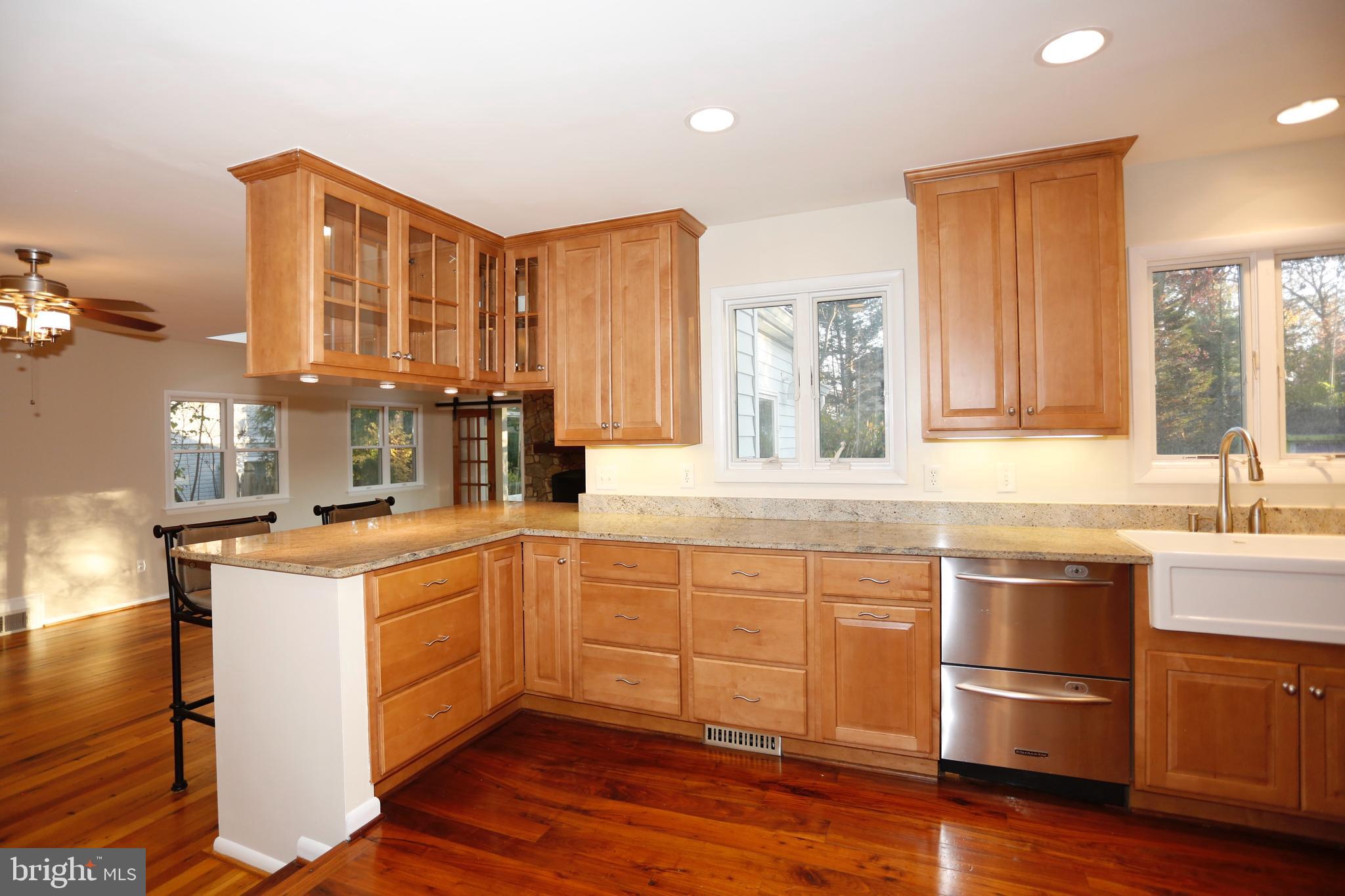 6308 Marywood Road Bethesda, MD 20817 - Photo 11 of 30 a kitchen with stainless steel appliances granite countertop a sink and cabinets