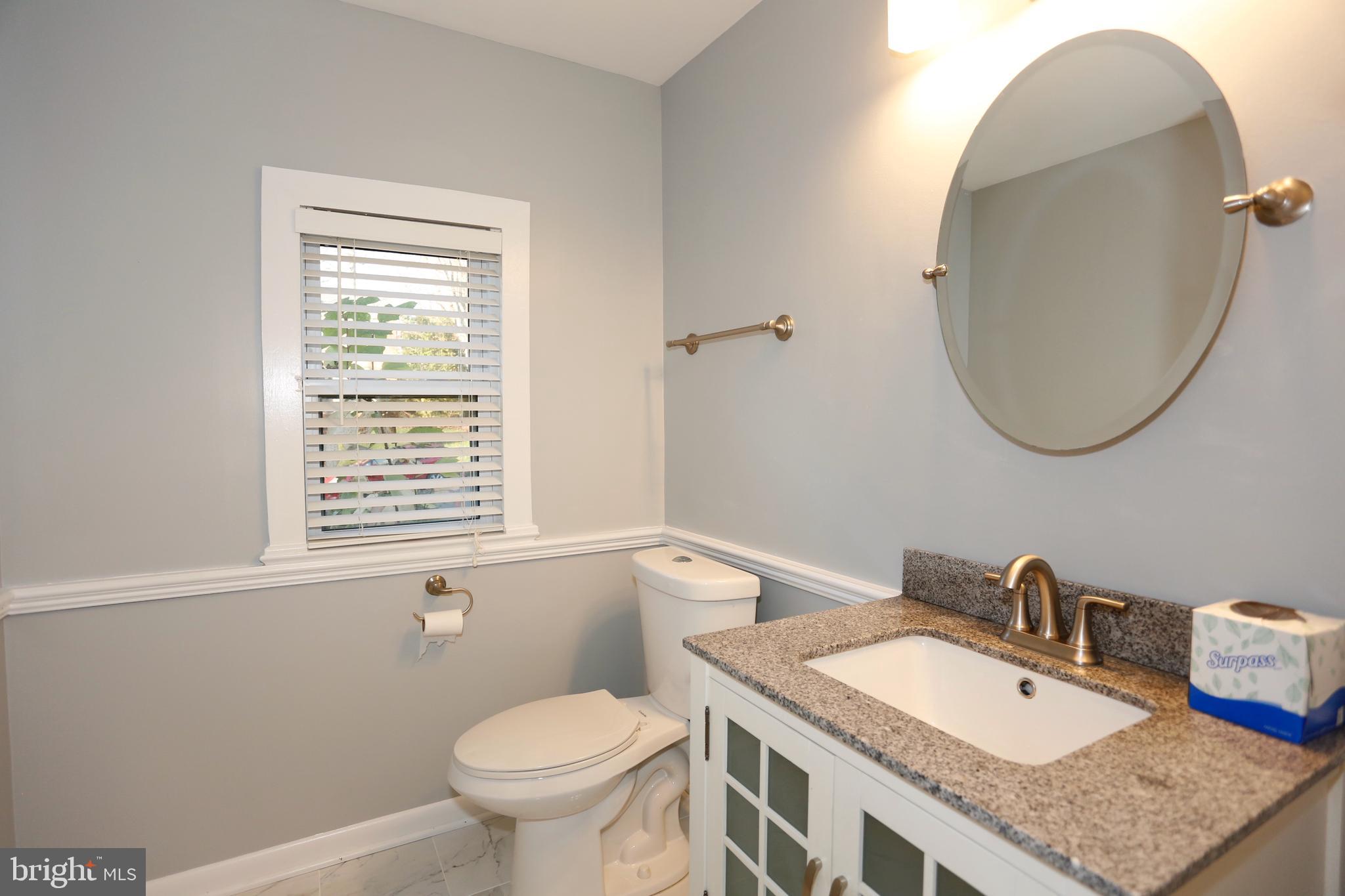 6308 Marywood Road Bethesda, MD 20817 - Photo 15 of 30 a bathroom with a granite countertop sink and a mirror