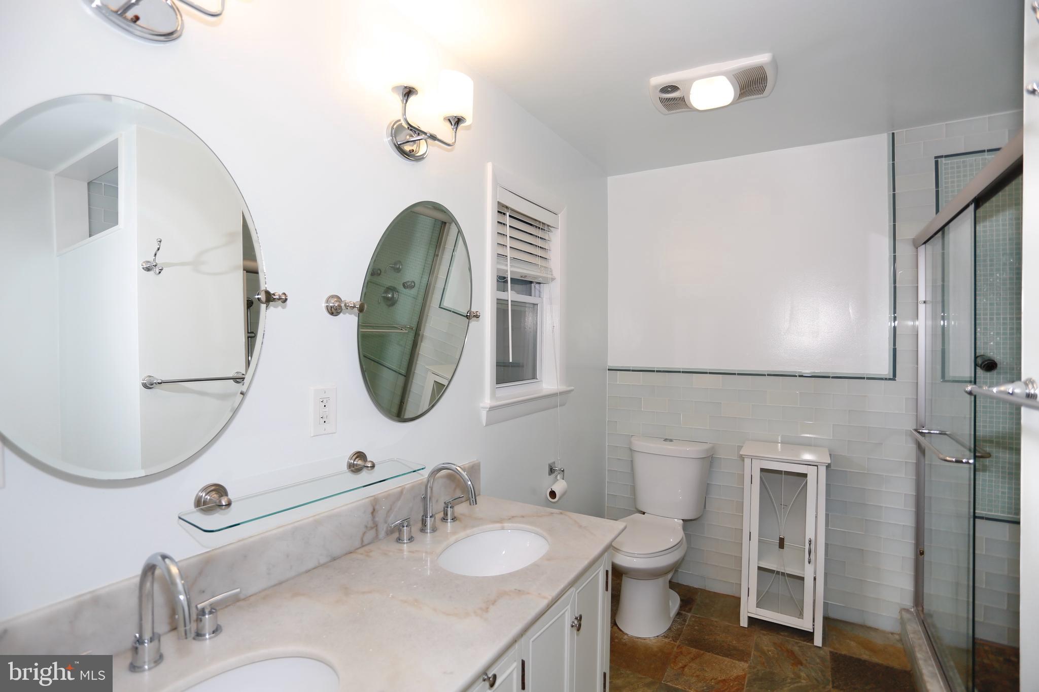 6308 Marywood Road Bethesda, MD 20817 - Photo 20 of 30 a bathroom with a granite countertop toilet sink and mirror