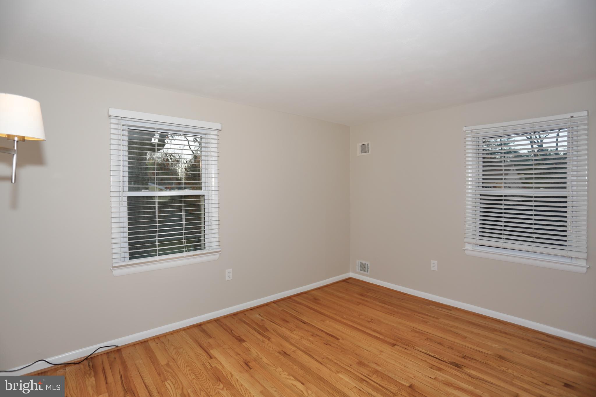6308 Marywood Road Bethesda, MD 20817 - Photo 25 of 30 a view of an empty room with wooden floor and a window