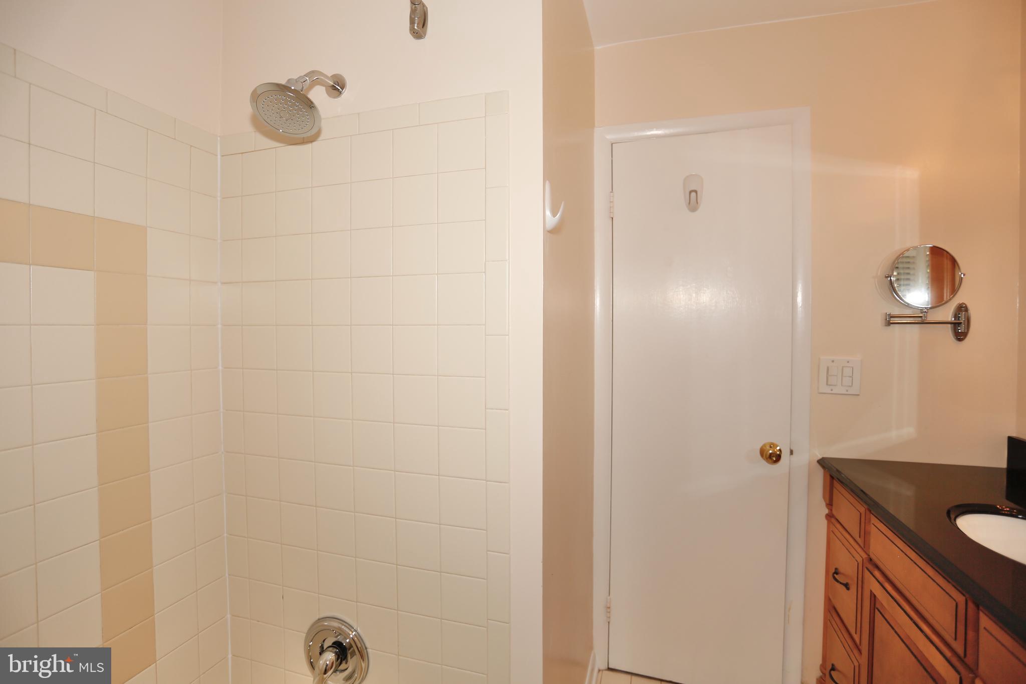 6308 Marywood Road Bethesda, MD 20817 - Photo 27 of 30 a bathroom with a granite countertop shower