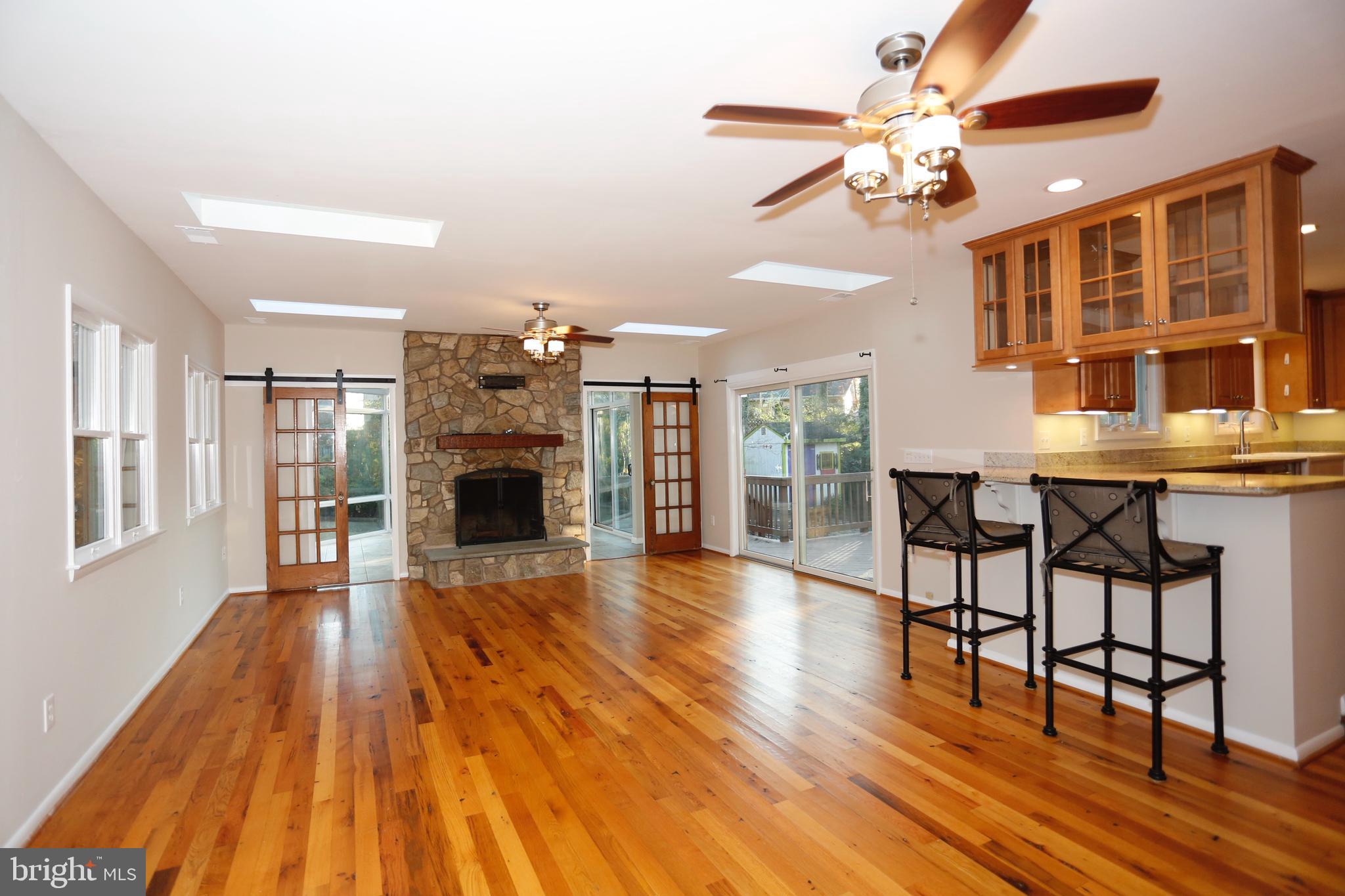 6308 Marywood Road Bethesda, MD 20817 - Photo 7 of 30 a view of a livingroom with furniture a fireplace wooden floor and chandelier