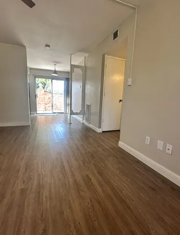 wooden floor in an empty room with a window