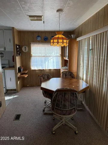 a kitchen with stainless steel appliances granite countertop a refrigerator a stove and white cabinets with wooden floor