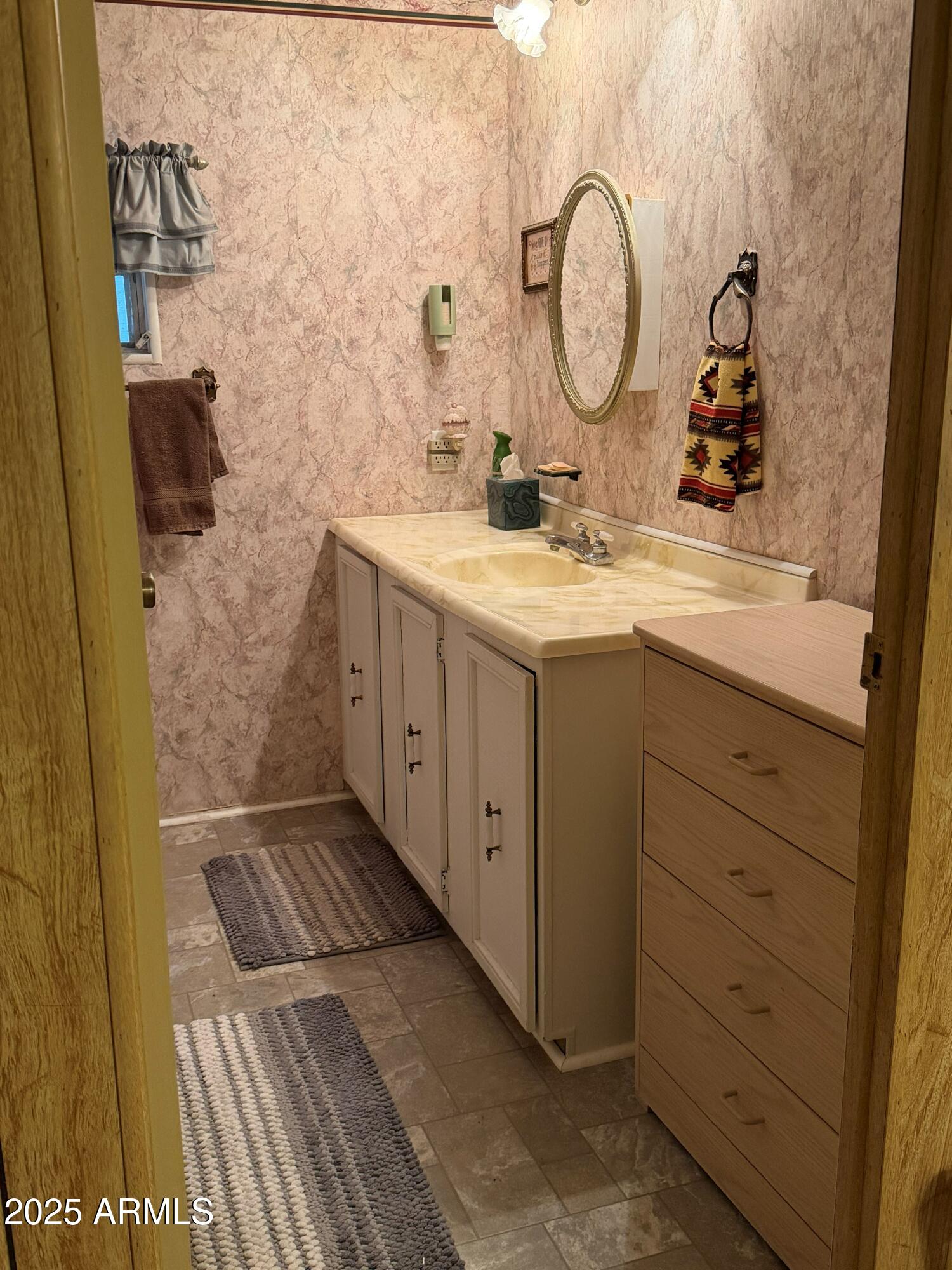 939 North Acacia Road, Unit 25 Apache Junction, AZ 85119 - Photo 18 of 25 a bathroom with a sink and a mirror