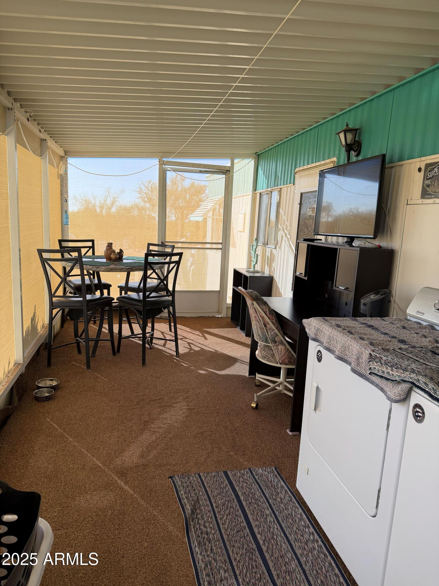 939 North Acacia Road, Unit 25 Apache Junction, AZ 85119 - Photo 8 of 25 a view of a patio with table and chairs