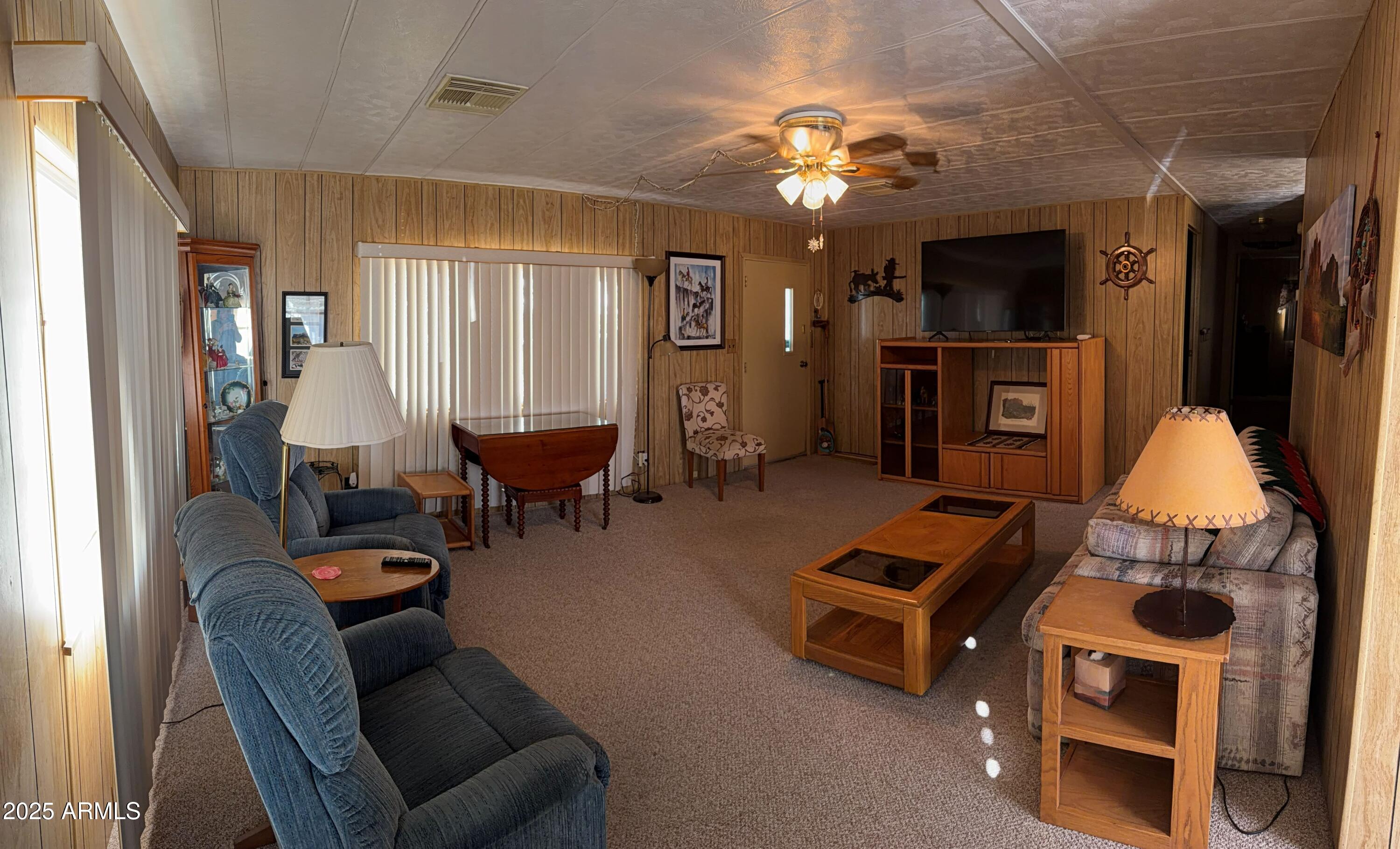 939 North Acacia Road, Unit 25 Apache Junction, AZ 85119 - Photo 10 of 25 a living room with furniture and a chandelier