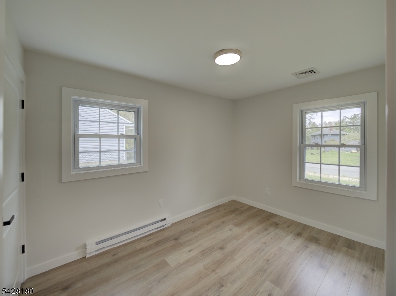13 Fillmore Street Washington, NJ 07882 - Photo 13 of 21 an empty room with wooden floor and windows