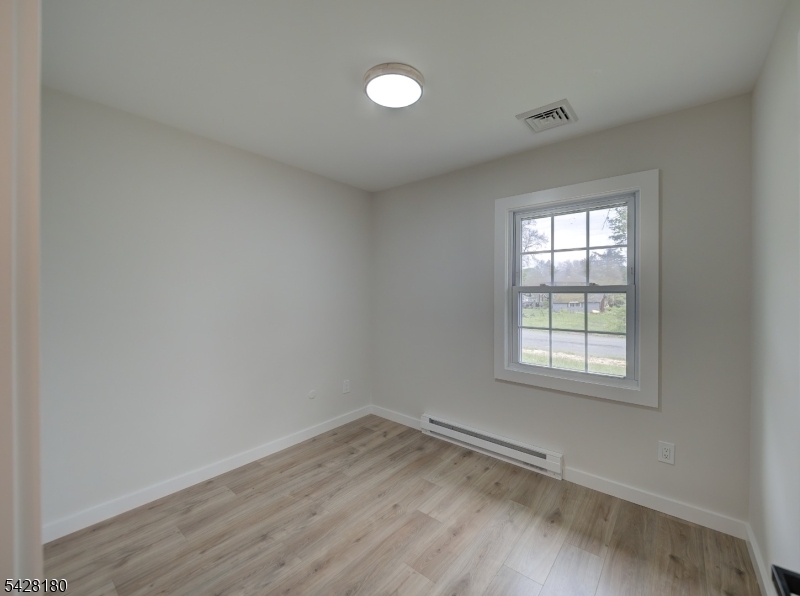 13 Fillmore Street Washington, NJ 07882 - Photo 15 of 21 an empty room with wooden floor and windows