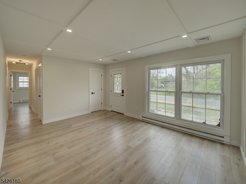 13 Fillmore Street Washington, NJ 07882 - Photo 4 of 21 an empty room with wooden floor and windows