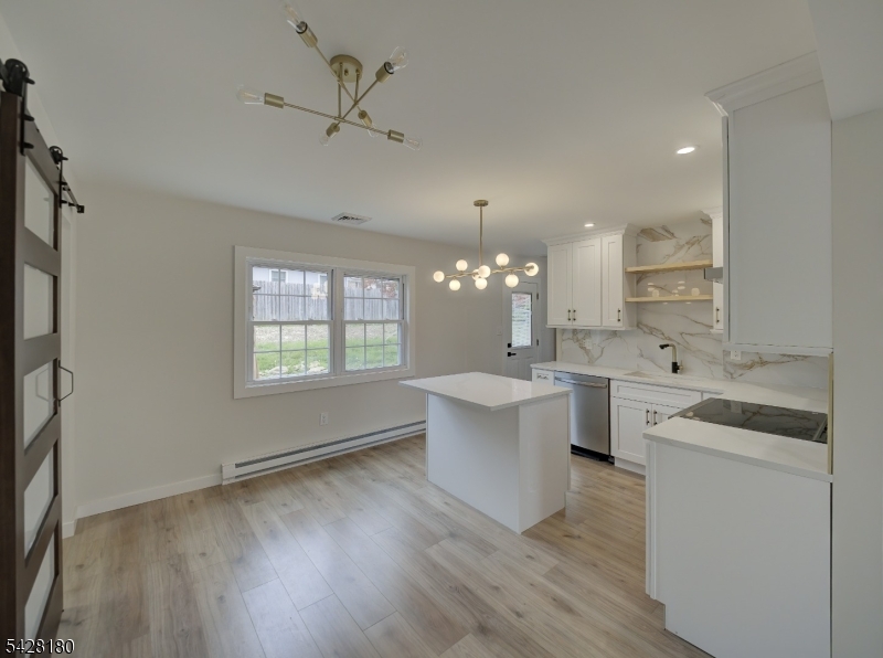 13 Fillmore Street Washington, NJ 07882 - Photo 8 of 21 a large kitchen with kitchen island a white counter space a sink and a window