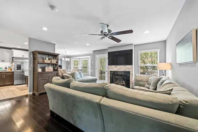 a living room with furniture a fireplace and a flat screen tv