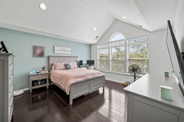 a spacious bedroom with a bed and a large window