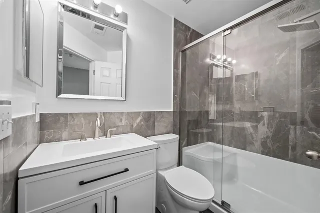 a bathroom with a sink toilet and shower