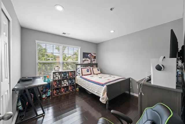 a bedroom with furniture and a flat screen tv