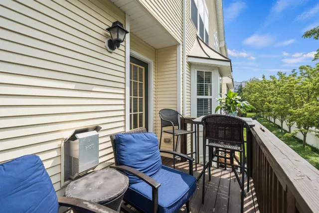 a view of a patio with table and chairs and wooden floor