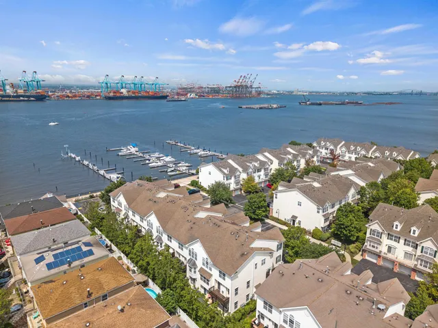 an aerial view of a houses with ocean view