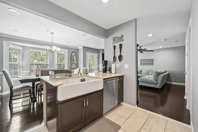 a kitchen with kitchen island a white counter space a sink appliances and a window
