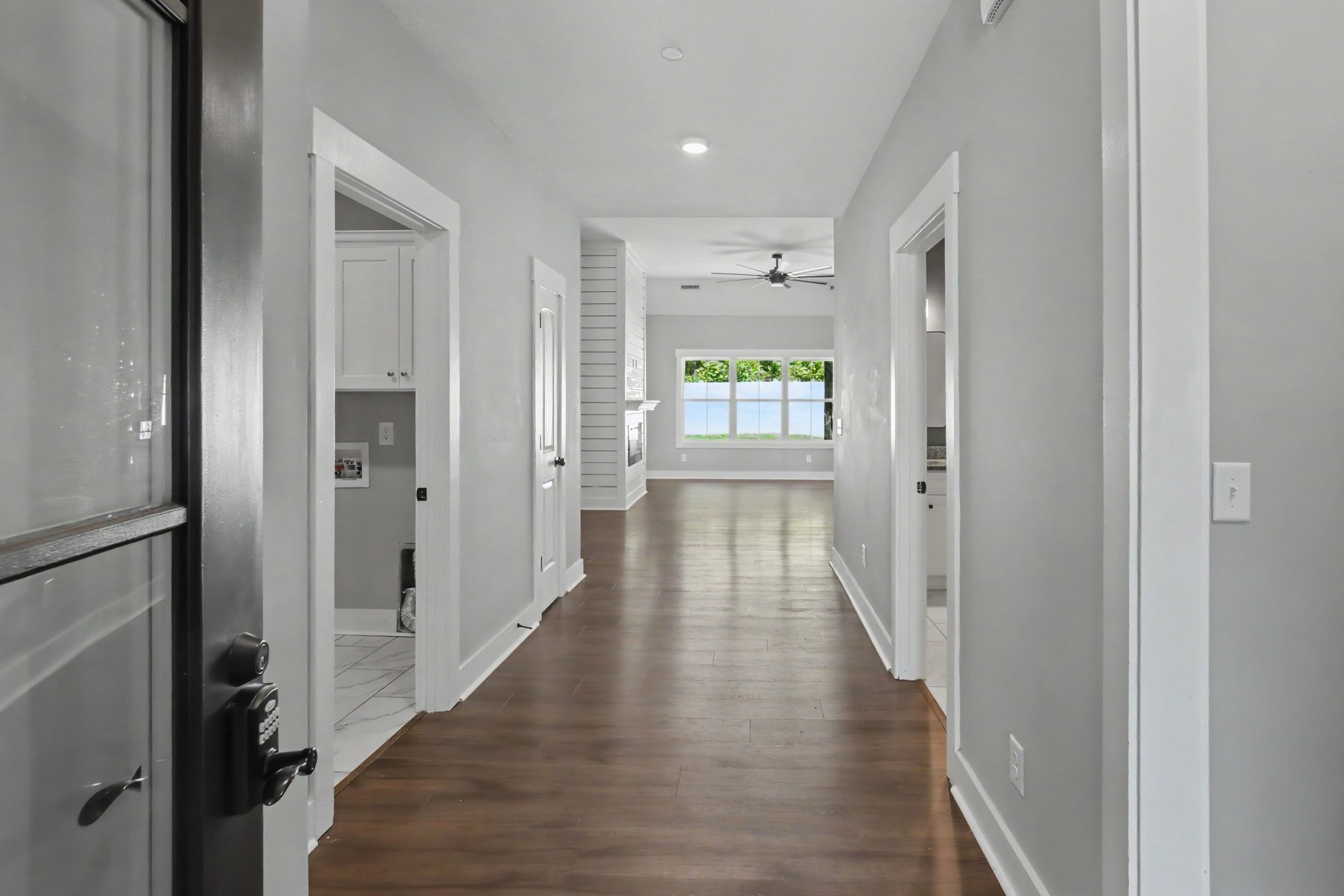 7208 Winding Way Pleasant View, TN 37146 - Photo 6 of 30 a view of a hallway with wooden floor and a living room