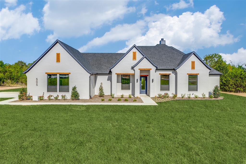 505 Aermotor Loop Weatherford, TX 76085 - Photo 1 of 17 a front view of a house with a garden and porch