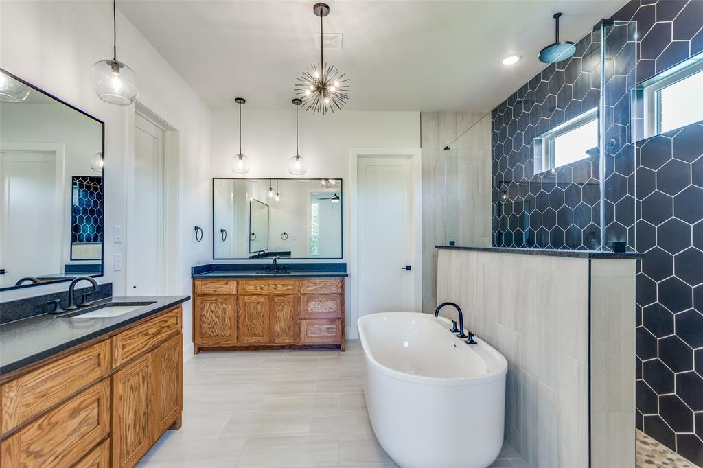 505 Aermotor Loop Weatherford, TX 76085 - Photo 12 of 17 a large bathroom with a granite countertop tub sink and mirror