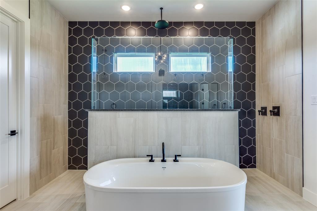 505 Aermotor Loop Weatherford, TX 76085 - Photo 13 of 17 a bathroom with a bathtub and a shower