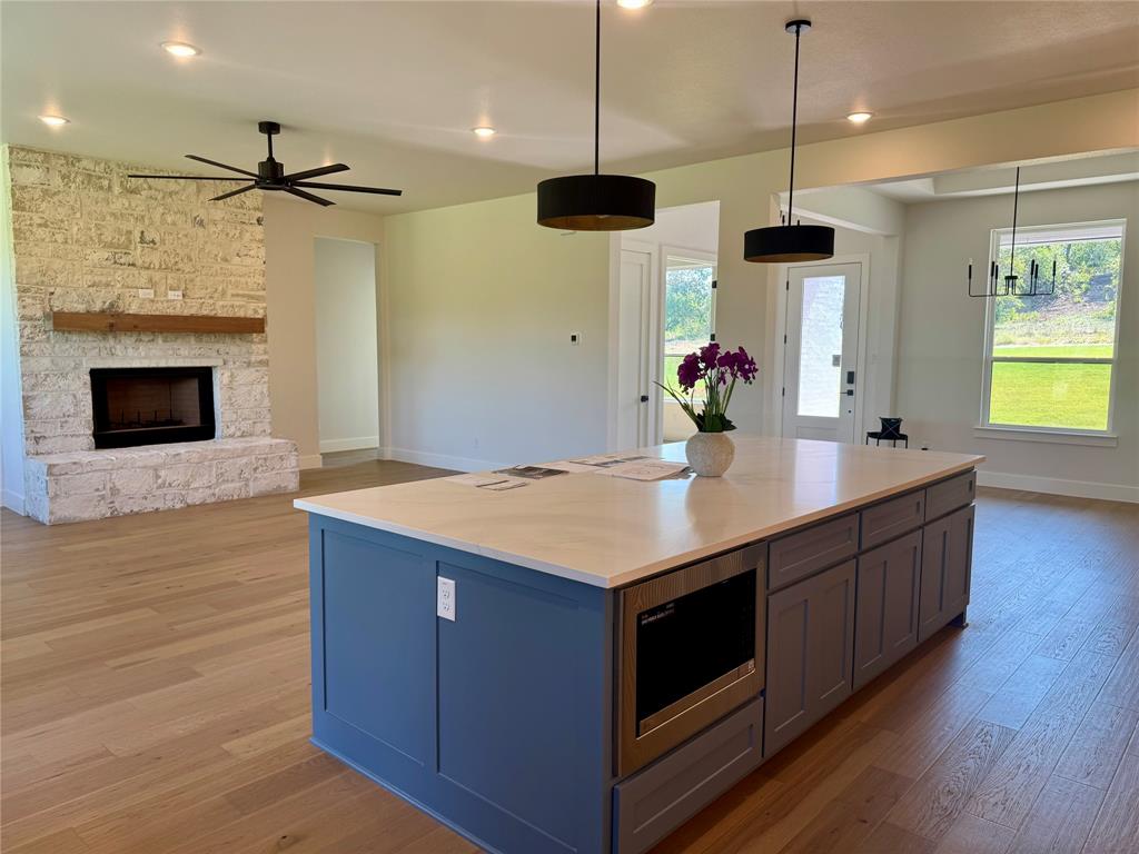 505 Aermotor Loop Weatherford, TX 76085 - Photo 9 of 17 a kitchen with stainless steel appliances granite countertop wooden floors and granite counter tops