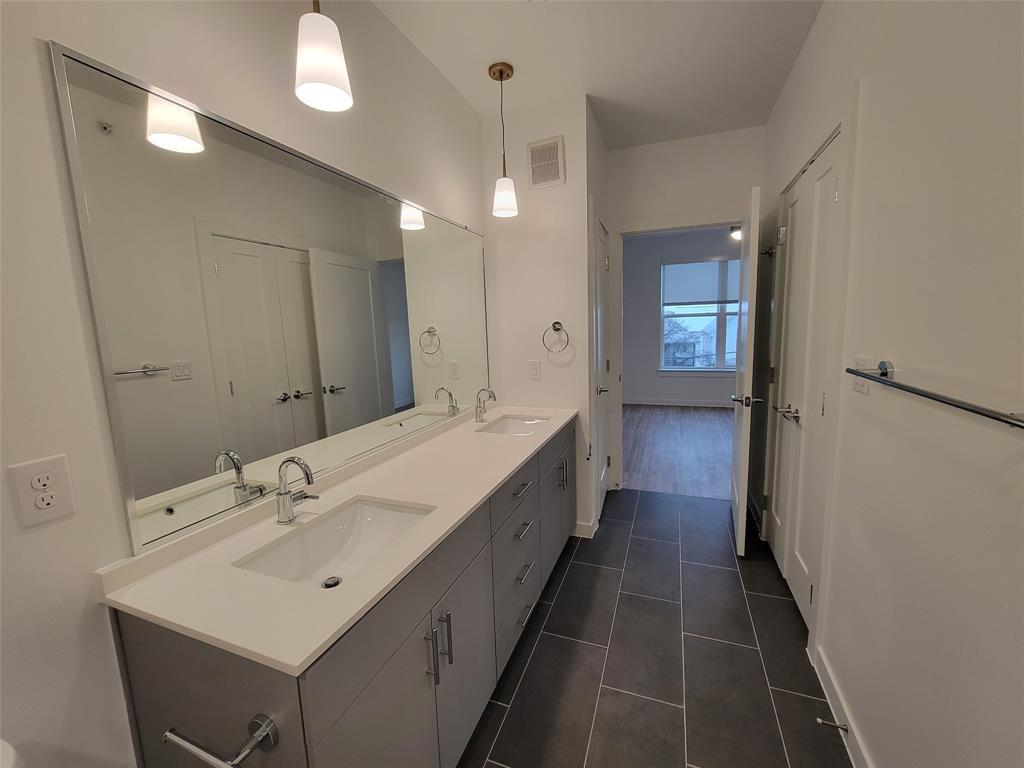 4801 Springdale Road, Unit 2211 Austin, TX 78723 - Photo 13 of 19 Dual vanities with abundant counter space provide functionality in this primary bathroom.