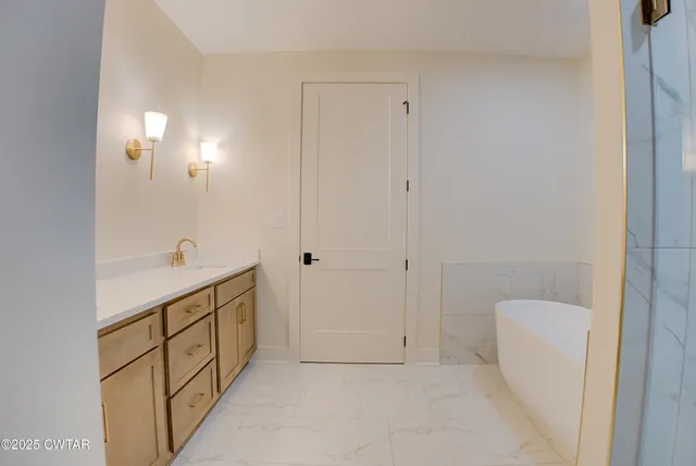 a white bath tub sitting next to a shower