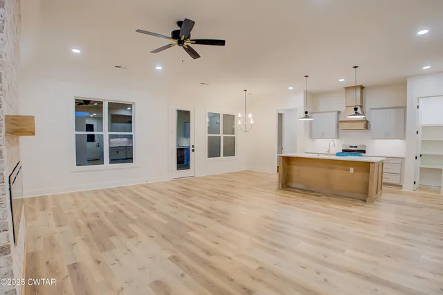 a view of an empty room with a kitchen