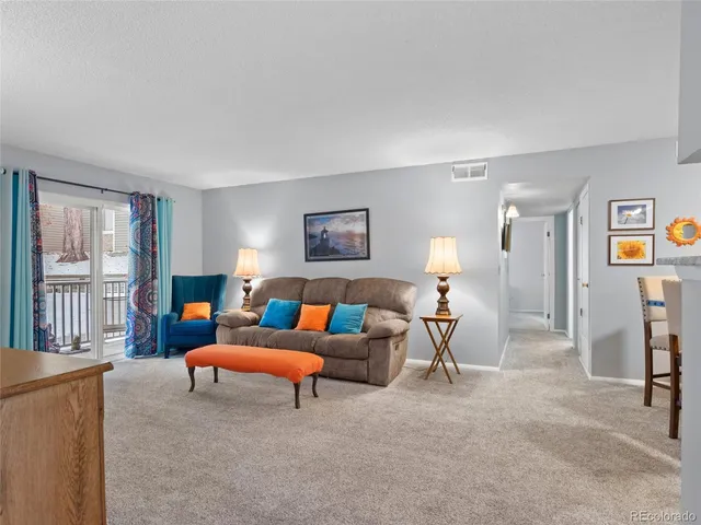 a living room with furniture and a lamp