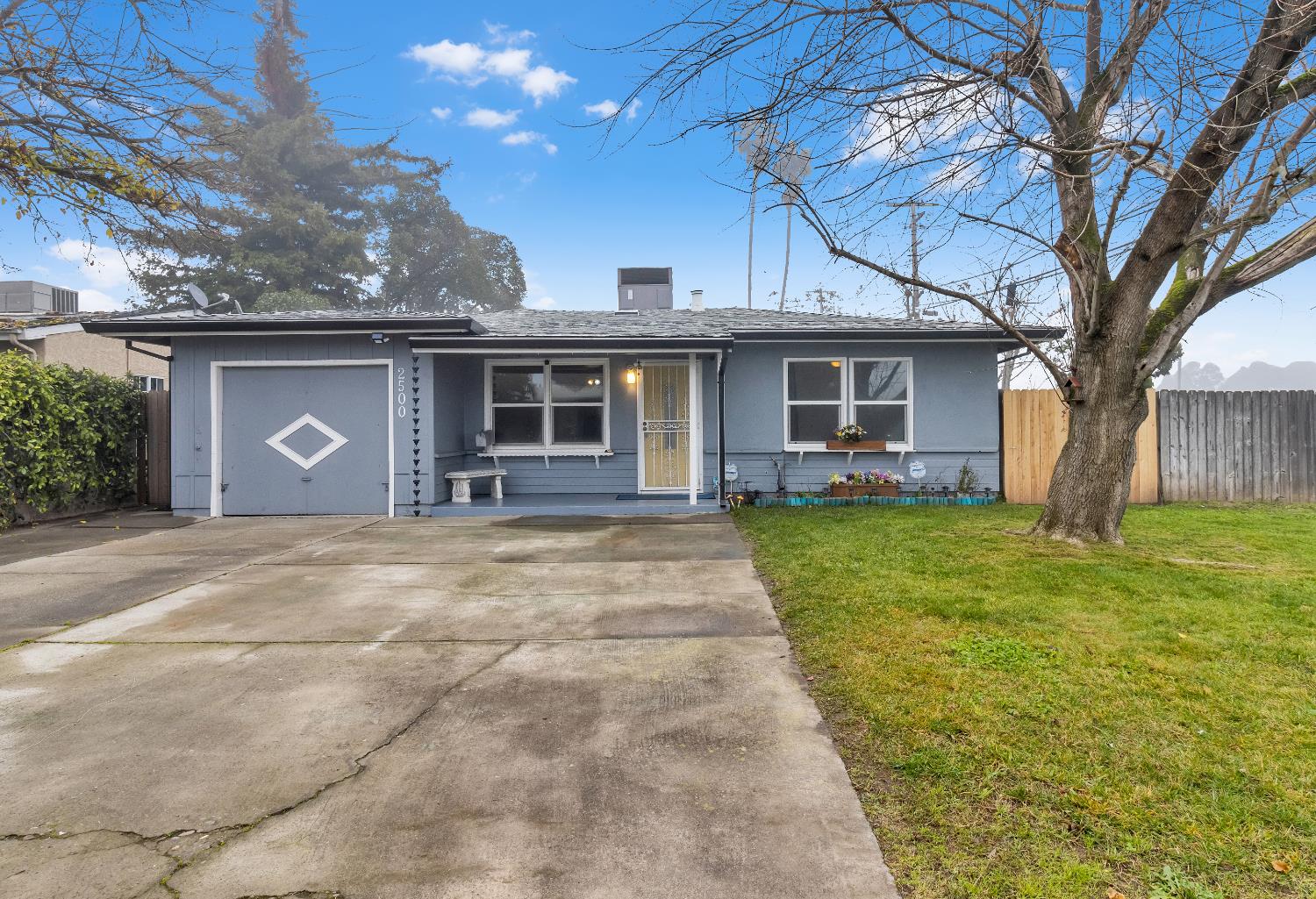 2500 Ethan Way Sacramento, CA 95821 - Photo 2 of 28 a front view of a house with a garden and trees