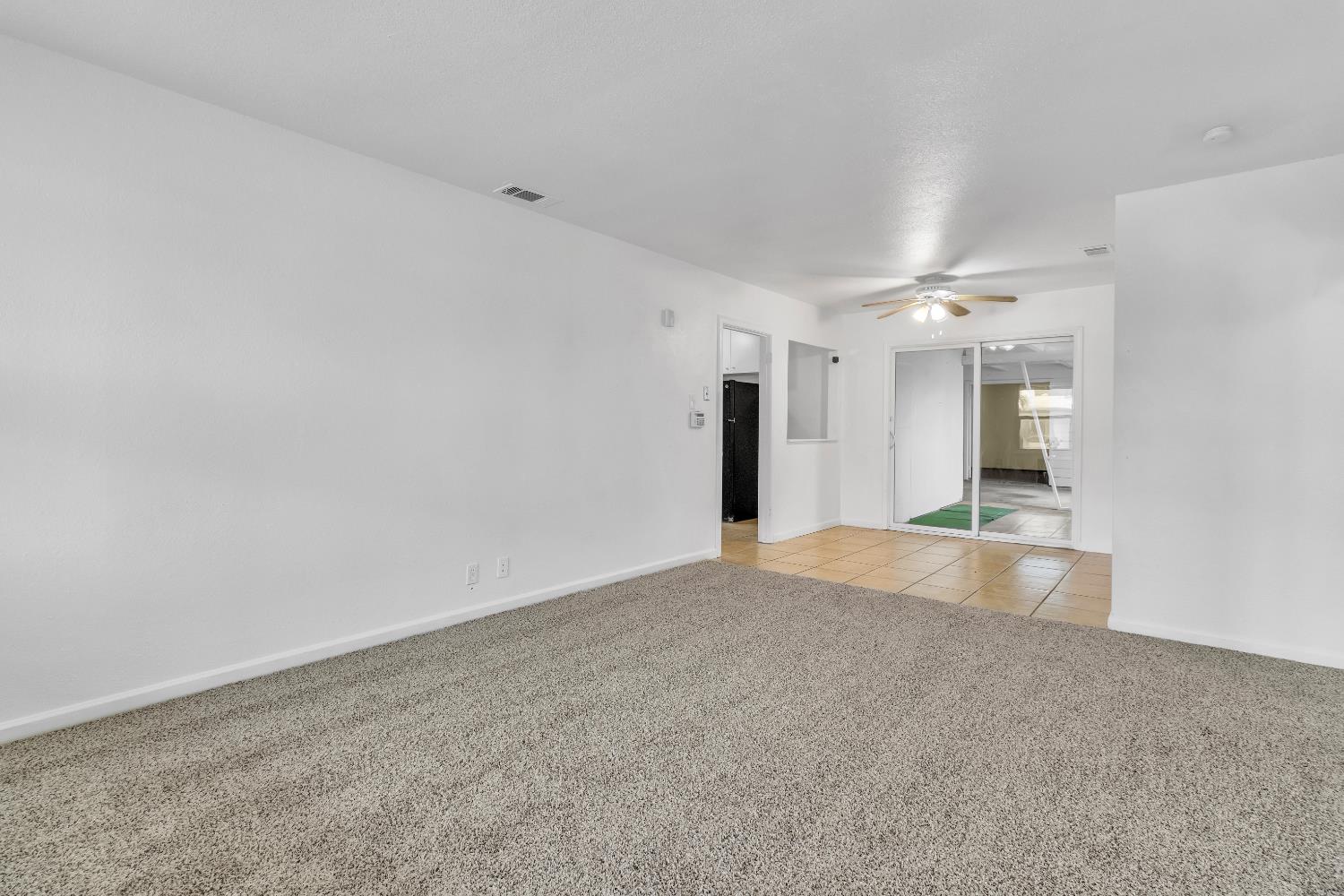 2500 Ethan Way Sacramento, CA 95821 - Photo 5 of 28 a view of an empty room with kitchen and chandelier