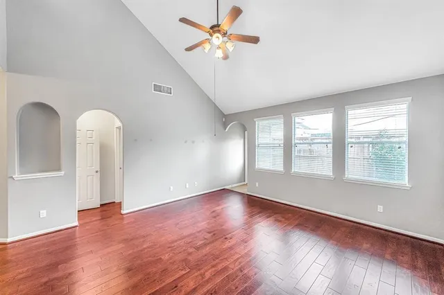 wooden floor in an empty room with a window