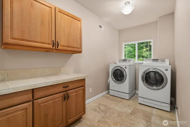 a utility room with sink dryer and washer