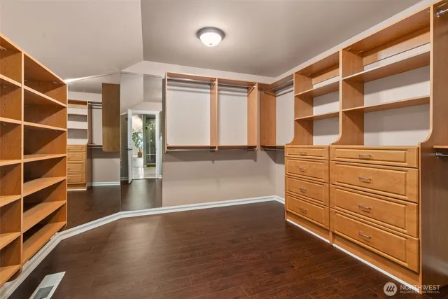 a view of walk in closet with empty racks