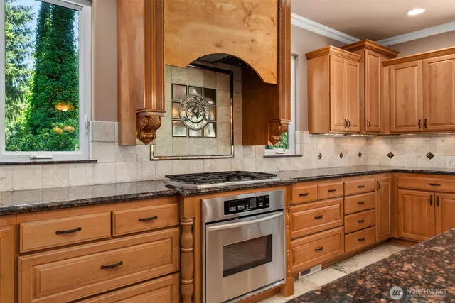 a kitchen with granite countertop a stove and a sink