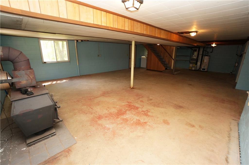 284 Mansfield Road Washington, PA 15301 - Photo 22 of 25 Basement game room area measures a whopping 28x25' (m/l) and features a wood burner for heat, two windows & a door leading directly to driveway area.