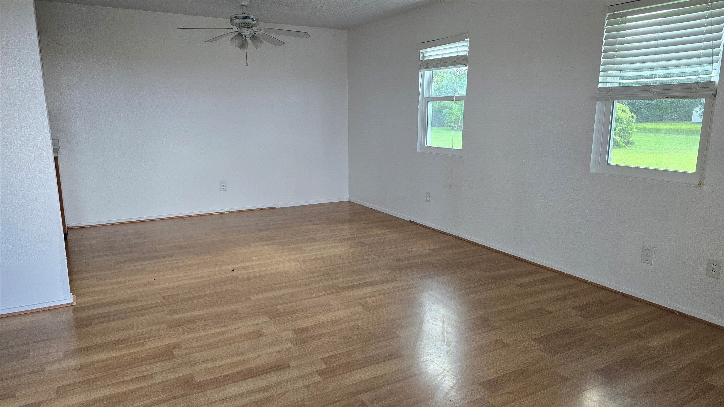 2739 Lawrence Road, Unit B Kemah, TX 77565 - Photo 3 of 10 an empty room with wooden floor and windows