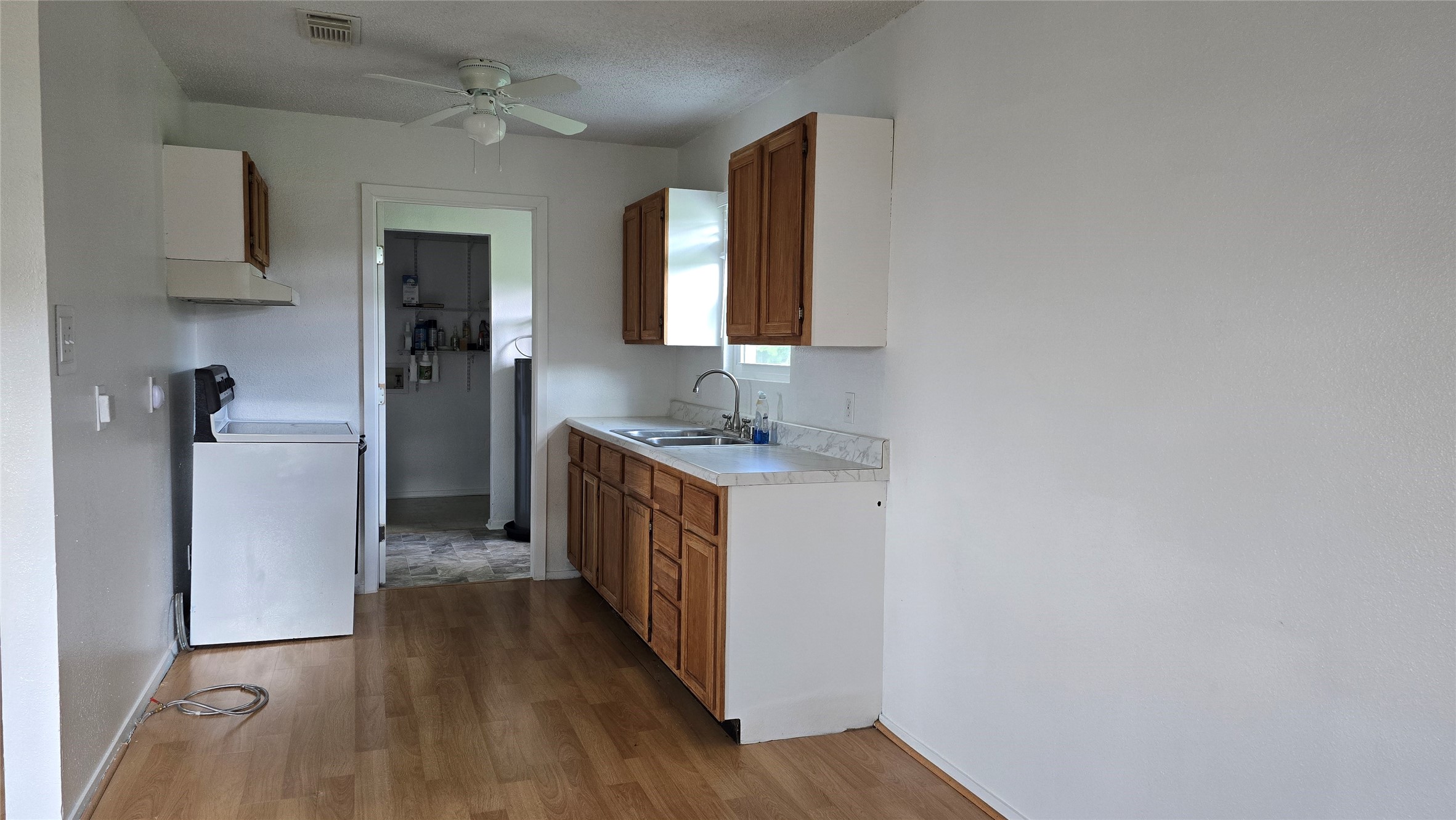 2739 Lawrence Road, Unit B Kemah, TX 77565 - Photo 4 of 10 a kitchen with sink and refrigerator