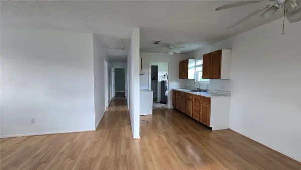 a view of a kitchen cabinets wooden floor and a window