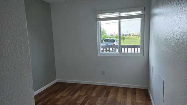 a view of an empty room and a window