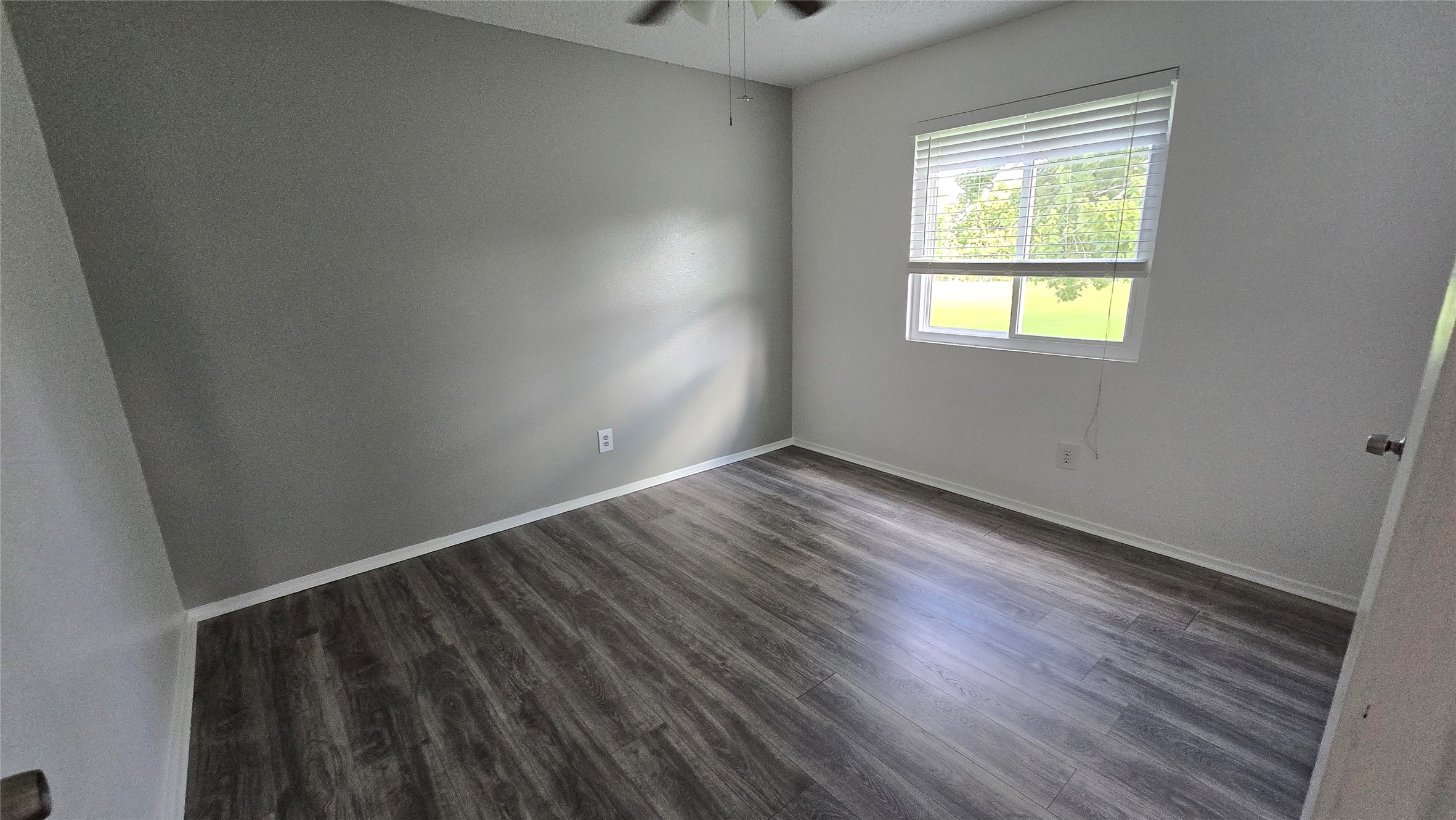 2739 Lawrence Road, Unit B Kemah, TX 77565 - Photo 8 of 10 a view of an empty room with wooden floor and a window