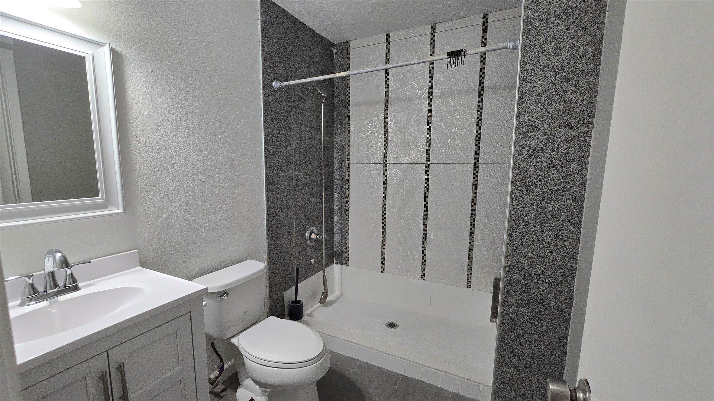 2739 Lawrence Road, Unit B Kemah, TX 77565 - Photo 9 of 10 a bathroom with a granite countertop sink toilet and shower