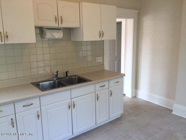 3308 St Augustine Road Jacksonville, FL 32207 - Photo 13 of 21 a kitchen with white cabinets and a sink