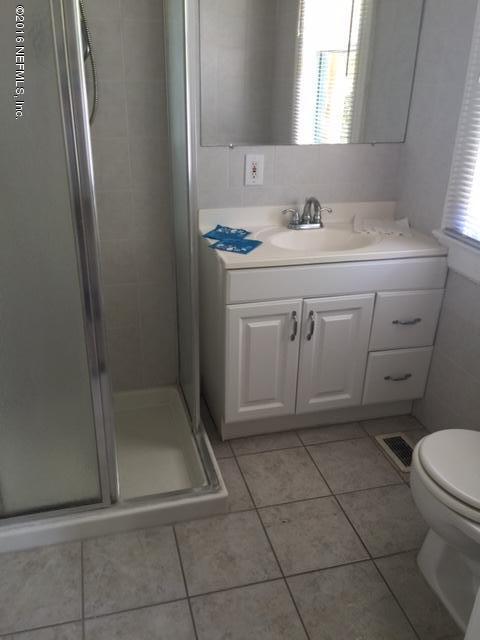 3308 St Augustine Road Jacksonville, FL 32207 - Photo 18 of 21 a bathroom with a sink a toilet and a mirror
