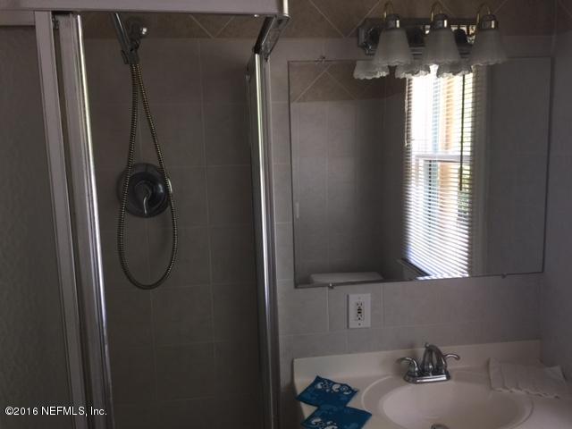 3308 St Augustine Road Jacksonville, FL 32207 - Photo 19 of 21 a bathroom with a shower and a mirror