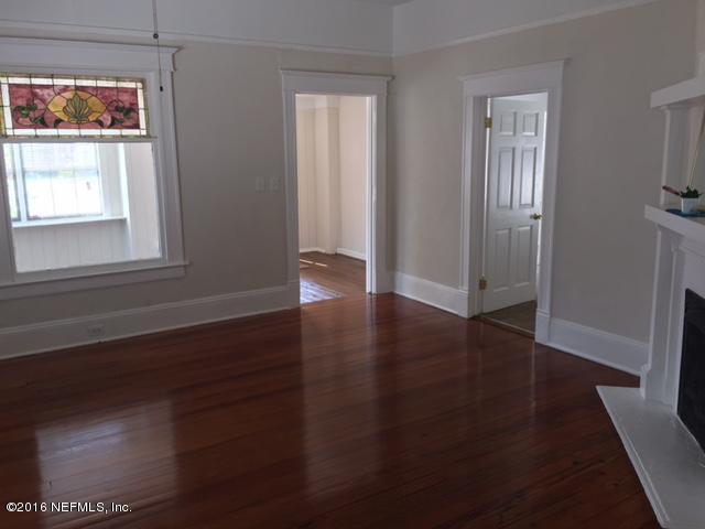 3308 St Augustine Road Jacksonville, FL 32207 - Photo 21 of 21 an empty room with wooden floor and windows