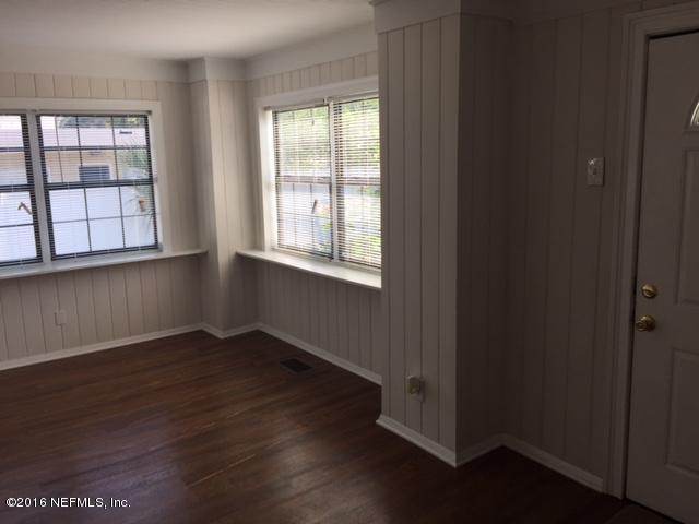 3308 St Augustine Road Jacksonville, FL 32207 - Photo 4 of 21 an empty room with wooden floor and windows